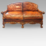 Edwardian walnut and leather bergere sofa