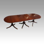 George V mahogany triple pillar dining table