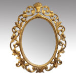 Antique carved oval gilt mirror