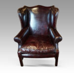 George VI maroon leather wing chair