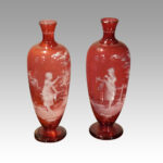 Pair of Mary Gregory cranberry glass vases with girls