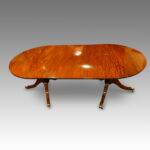 Regency style mahogany twin pillar dining table
