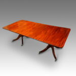 Regency style twin pillar mahogany dining table with line inlay