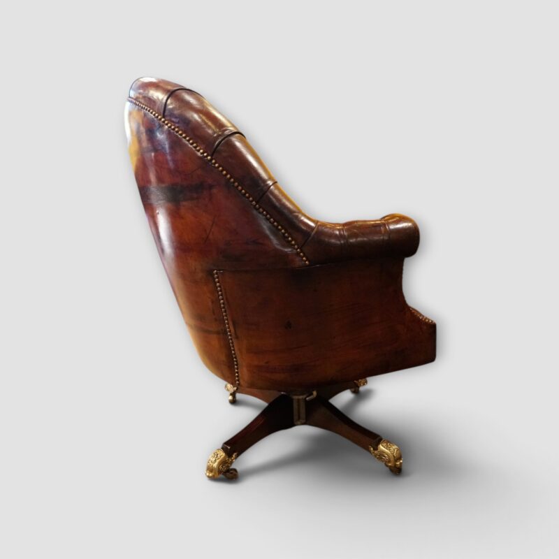 Antique leather desk chair with deep buttoning