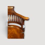 Antique desk chair showing curved arms