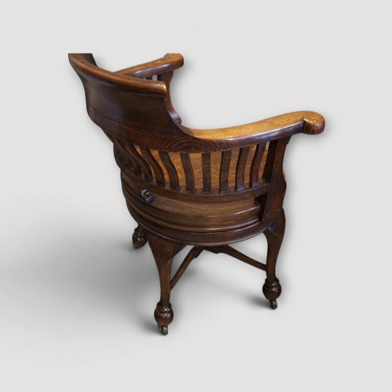 Side profile of Edwardian oak swivel chair