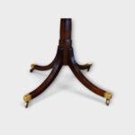 Twin‑pillar dining table with brass‑footed legs