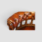 Close‑up of buttoned leather back on Victorian desk chair