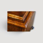 Feather‑banded walnut chest‑on‑chest