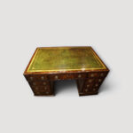 Moss‑green leather writing surface with gilt tooling