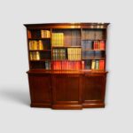Edwardian mahogany breakfront bookcase with open shelves and cupboards below