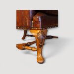 Close up of carved shell knee on Queen Anne style cabriole leg