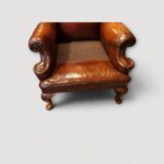 Pair of leather Queen Anne style wing chairs seat no cushion