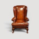 Luxury leather wing chairs with brass studded detailing